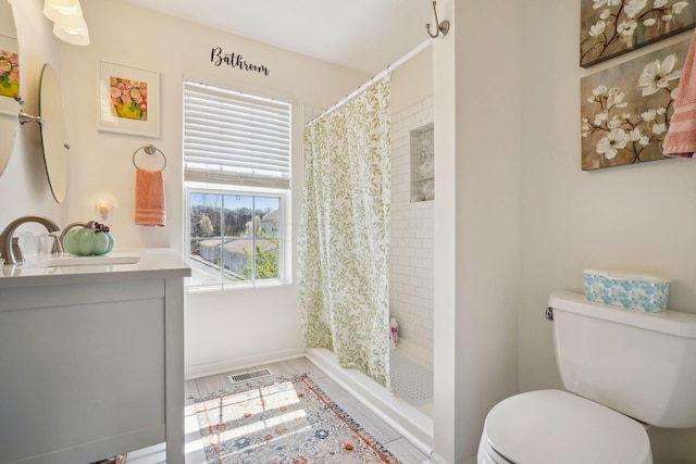 full bath with toilet, a stall shower, visible vents, and a wealth of natural light