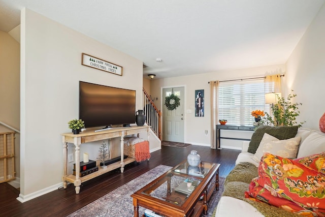 living room with baseboards, wood finished floors, and stairs