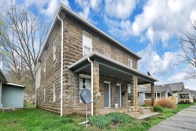 820 Poplar St Unit 820/822, Nelsonville, OH 45764 - view of front facade with stone siding, a front lawn, and a porch