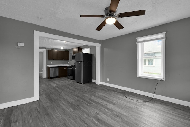 820 Poplar St Unit 820/822, Nelsonville, OH 45764 - unfurnished living room featuring baseboards, a textured ceiling, dark wood-style floors, and a ceiling fan