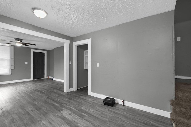 820 Poplar St Unit 820/822, Nelsonville, OH 45764 - unfurnished living room featuring a ceiling fan, dark wood-style floors, baseboards, and a textured ceiling