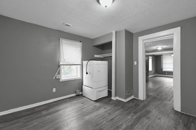 820 Poplar St Unit 820/822, Nelsonville, OH 45764 - clothes washing area with dark wood-style flooring, baseboards, a textured ceiling, washer / dryer, and laundry area
