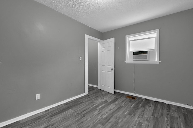 820 Poplar St Unit 820/822, Nelsonville, OH 45764 - empty room with baseboards, visible vents, dark wood-type flooring, and a textured ceiling