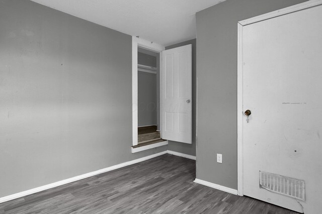 820 Poplar St Unit 820/822, Nelsonville, OH 45764 - unfurnished bedroom featuring baseboards, a closet, visible vents, and dark wood-type flooring