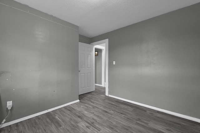 820 Poplar St Unit 820/822, Nelsonville, OH 45764 - unfurnished room featuring baseboards, a textured ceiling, and dark wood-style flooring