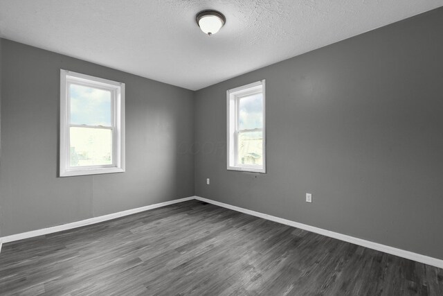 820 Poplar St Unit 820/822, Nelsonville, OH 45764 - empty room featuring dark wood-style flooring, baseboards, and a textured ceiling