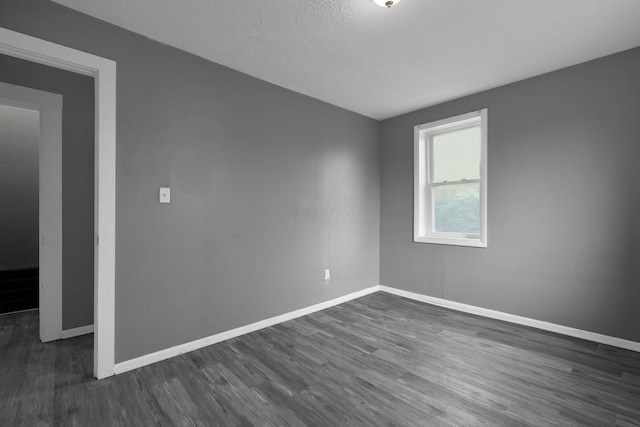 820 Poplar St Unit 820/822, Nelsonville, OH 45764 - spare room featuring baseboards, a textured ceiling, and dark wood-style floors