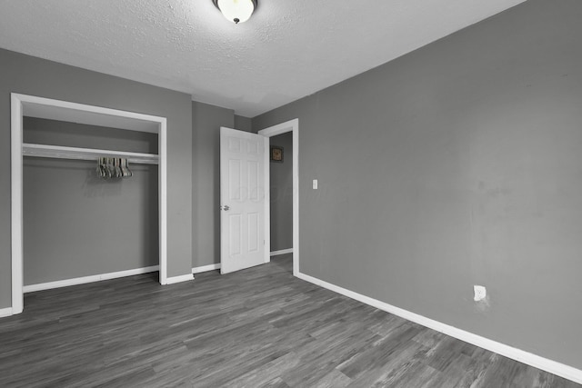 820 Poplar St Unit 820/822, Nelsonville, OH 45764 - unfurnished bedroom with baseboards, dark wood-style floors, a closet, and a textured ceiling