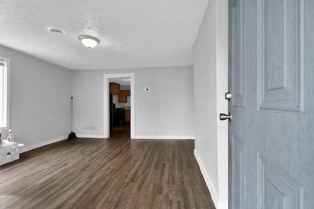 820 Poplar St Unit 820/822, Nelsonville, OH 45764 - unfurnished room featuring baseboards, dark wood-style flooring, a textured ceiling, and visible vents