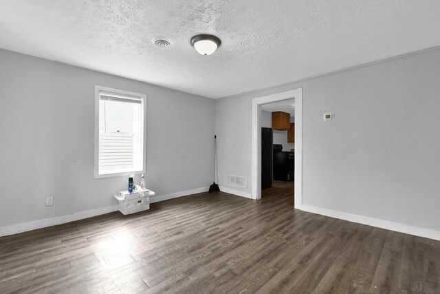820 Poplar St Unit 820/822, Nelsonville, OH 45764 - spare room with baseboards, visible vents, dark wood-type flooring, and a textured ceiling