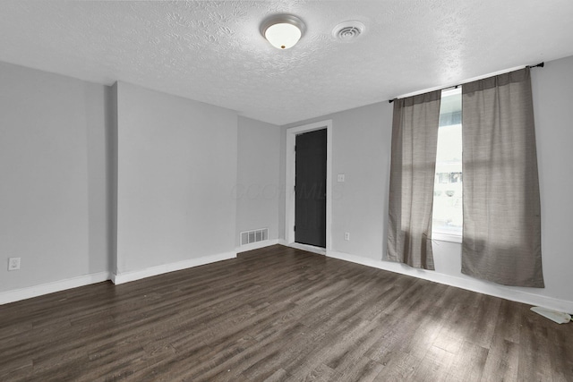 820 Poplar St Unit 820/822, Nelsonville, OH 45764 - spare room with baseboards, visible vents, dark wood-type flooring, and a textured ceiling
