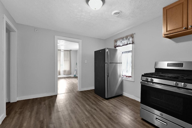 820 Poplar St Unit 820/822, Nelsonville, OH 45764 - kitchen featuring dark wood-style flooring, appliances with stainless steel finishes, a healthy amount of sunlight, and brown cabinets