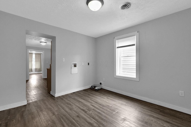 820 Poplar St Unit 820/822, Nelsonville, OH 45764 - empty room featuring a textured ceiling, visible vents, baseboards, and dark wood-style flooring