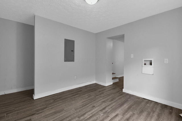 820 Poplar St Unit 820/822, Nelsonville, OH 45764 - spare room featuring dark wood finished floors, a textured ceiling, baseboards, and electric panel