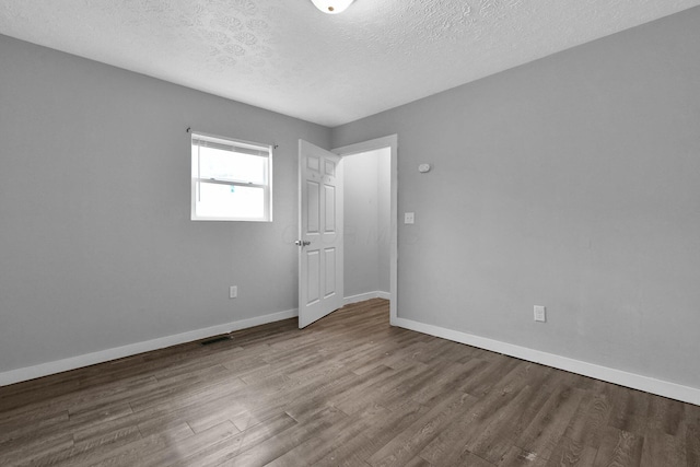 820 Poplar St Unit 820/822, Nelsonville, OH 45764 - spare room with baseboards, visible vents, wood finished floors, and a textured ceiling