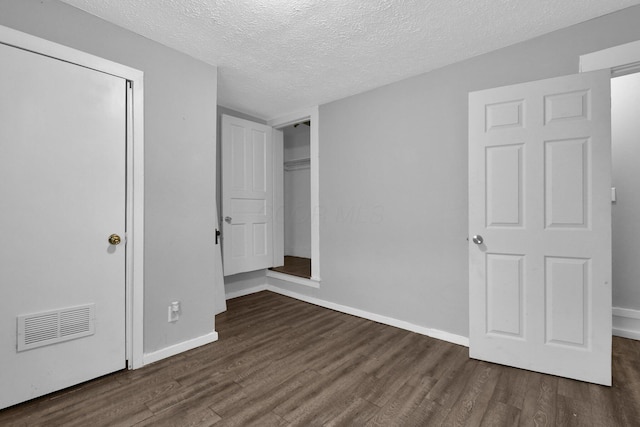 820 Poplar St Unit 820/822, Nelsonville, OH 45764 - unfurnished bedroom with baseboards, a textured ceiling, visible vents, and wood finished floors
