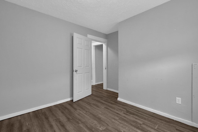 820 Poplar St Unit 820/822, Nelsonville, OH 45764 - spare room featuring a textured ceiling, baseboards, and dark wood finished floors