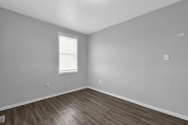 820 Poplar St Unit 820/822, Nelsonville, OH 45764 - spare room with dark wood-style flooring, baseboards, and a textured ceiling