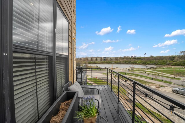 balcony featuring a water view