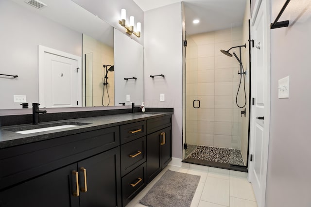 bathroom with a sink, a stall shower, double vanity, tile patterned flooring, and visible vents