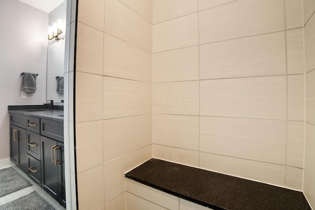 bathroom featuring baseboards and vanity