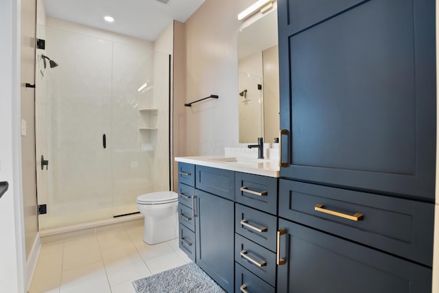 full bathroom featuring a stall shower, tile patterned floors, vanity, and toilet