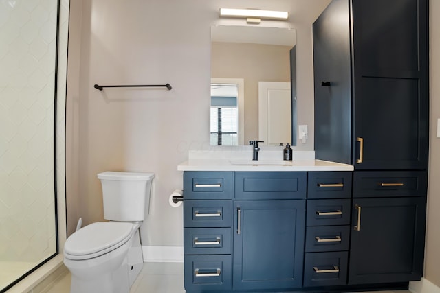 full bath with a shower stall, toilet, tile patterned floors, vanity, and baseboards