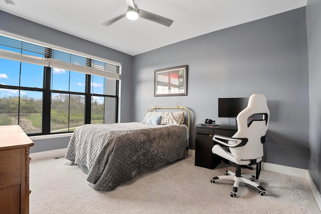 bedroom featuring baseboards, a ceiling fan, and carpet