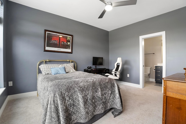 bedroom featuring a ceiling fan, baseboards, light carpet, and connected bathroom