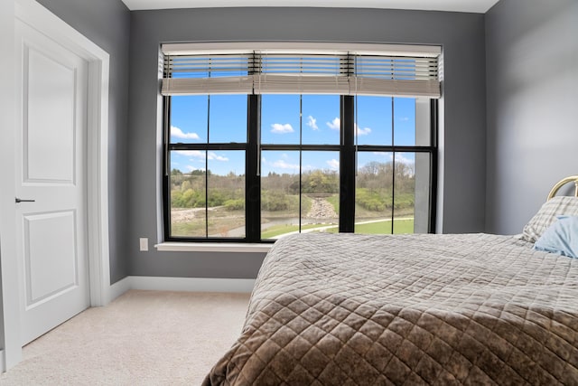 carpeted bedroom featuring baseboards