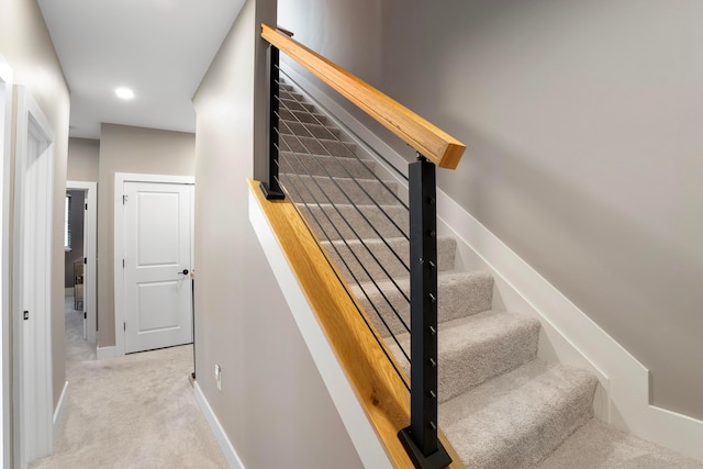 stairway with recessed lighting, baseboards, and carpet