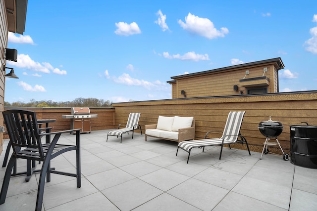 view of patio / terrace with a balcony and a grill