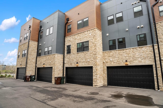 view of property with driveway and a garage