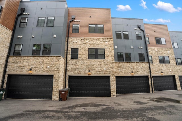 view of property with a garage and driveway