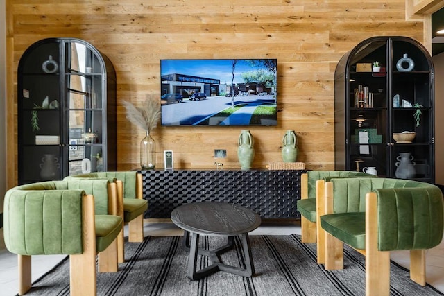 sitting room featuring wood walls