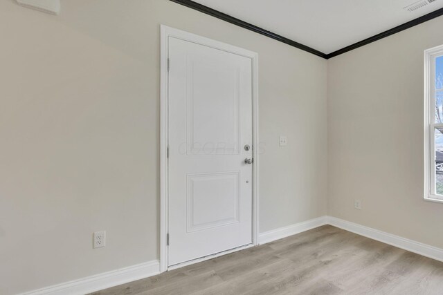 574 Koebel Ave, Columbus, OH 43207 - spare room featuring baseboards, ornamental molding, and light wood-style floors