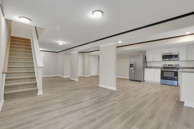 574 Koebel Ave, Columbus, OH 43207 - interior space featuring open floor plan, white cabinets, light wood finished floors, and appliances with stainless steel finishes