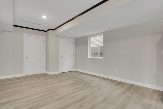 574 Koebel Ave, Columbus, OH 43207 - spare room featuring baseboards, visible vents, crown molding, and light wood-style floors