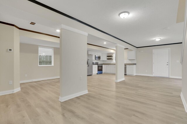 574 Koebel Ave, Columbus, OH 43207 - unfurnished living room with ornamental molding, baseboards, light wood finished floors, and visible vents