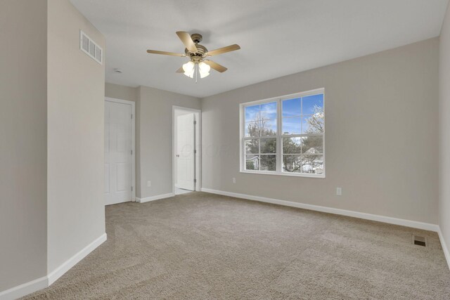 574 Koebel Ave, Columbus, OH 43207 - spare room featuring carpet flooring, a ceiling fan, baseboards, and visible vents