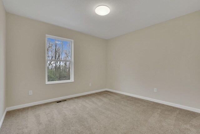 574 Koebel Ave, Columbus, OH 43207 - unfurnished room with baseboards, carpet floors, and visible vents