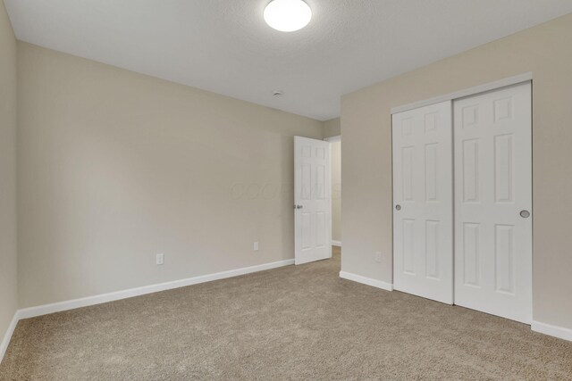 574 Koebel Ave, Columbus, OH 43207 - unfurnished bedroom featuring baseboards, a closet, and carpet flooring