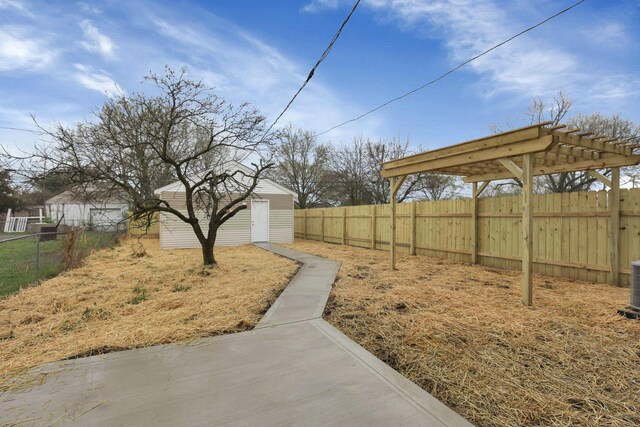 574 Koebel Ave, Columbus, OH 43207 - view of yard featuring an outbuilding, a storage unit, a fenced backyard, and a pergola