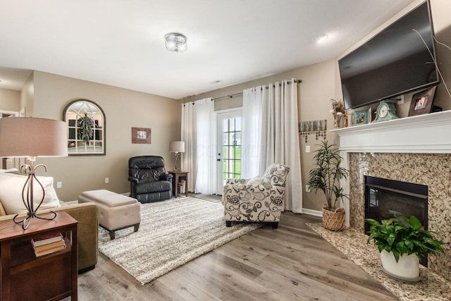 living area with a premium fireplace and wood finished floors