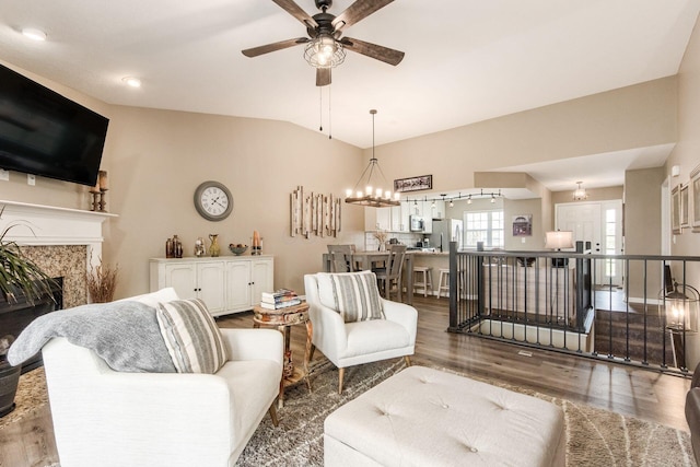 living area with ceiling fan, wood finished floors, and a high end fireplace