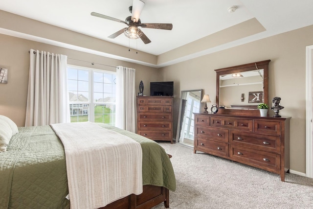 bedroom with light carpet and a ceiling fan