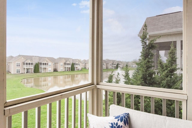 balcony with a water view and a residential view
