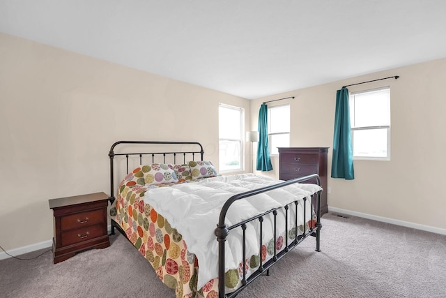 carpeted bedroom featuring baseboards