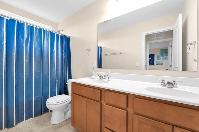 bathroom featuring tile patterned flooring, visible vents, a sink, and toilet