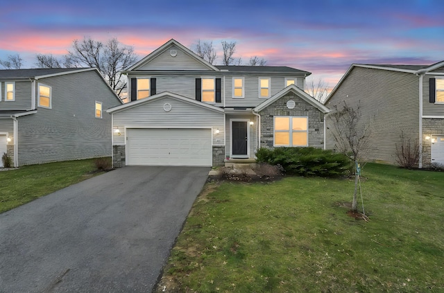 traditional home with a garage, driveway, stone siding, and a front lawn